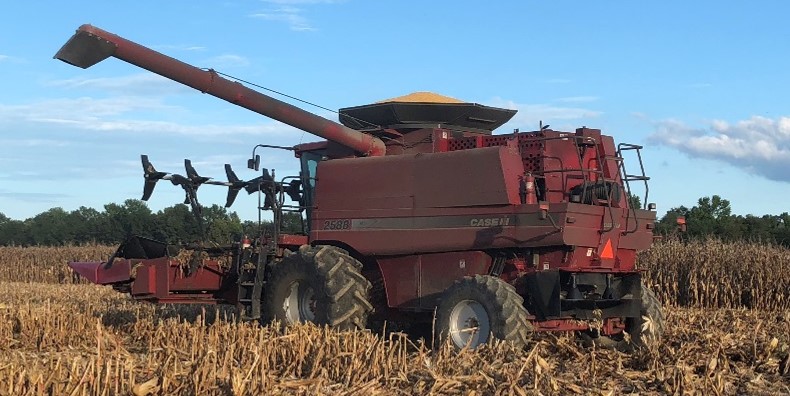 Combine with aftermarket header reel for harvesting lodged corn.