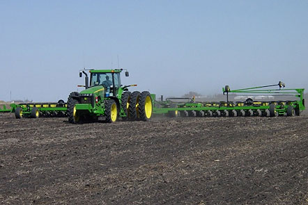 Photo - Green tractor - fieldwork in spring.