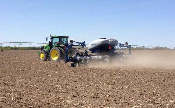 Photo - tractor running in field - early spring fieldwork.