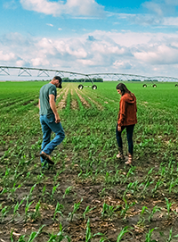 Photo - Farm couple walking in field.