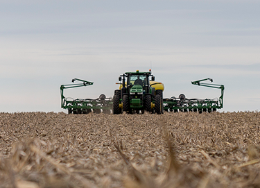 Photo - green planter in field - planting operation
